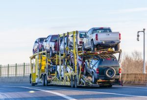 yellow-big-rig-car-hauler-with-several-cars-loaded