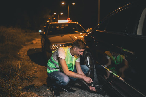 roadside assistance helping fix a tire