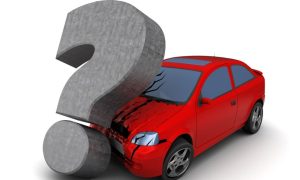 A large stone gray question mark damaging the front of a car, indicating the question, “what is towing and recovery?”