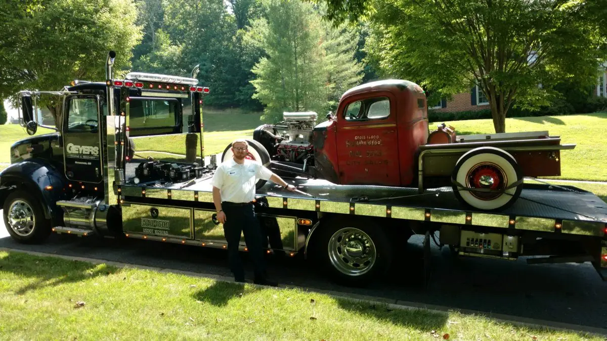 Geyers rollback carrying a classic pickup truck