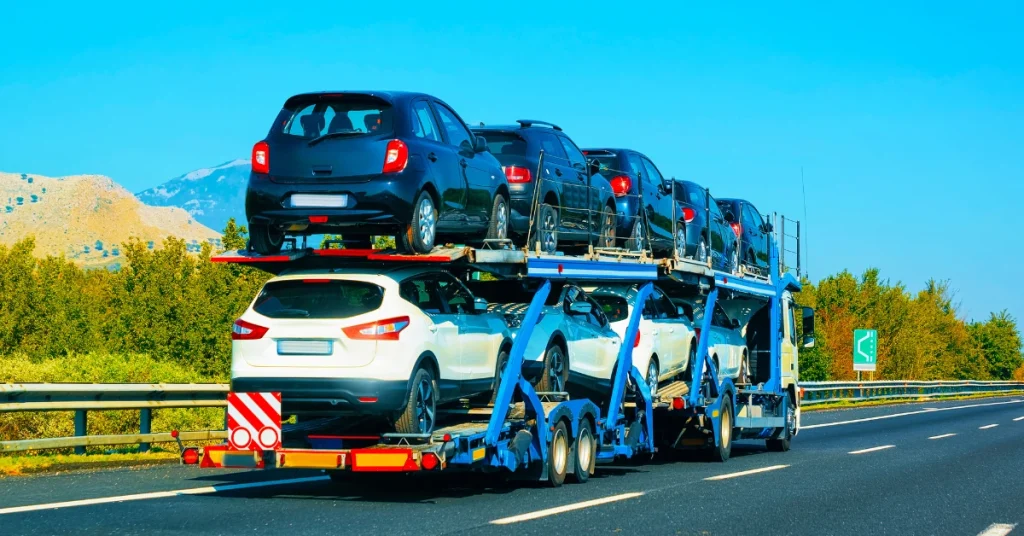 Car transport trailer on highway.