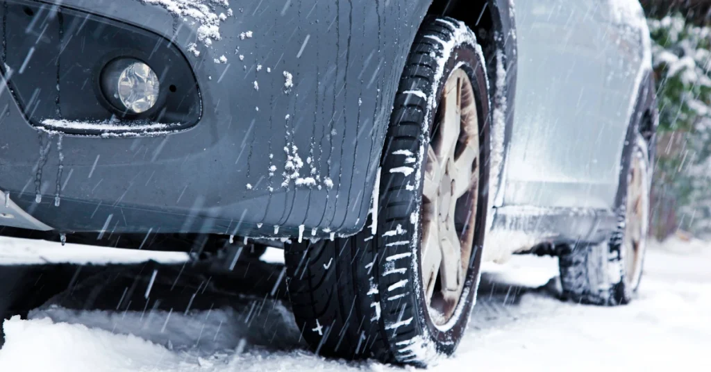 Car with winter tires driving on a snowy road