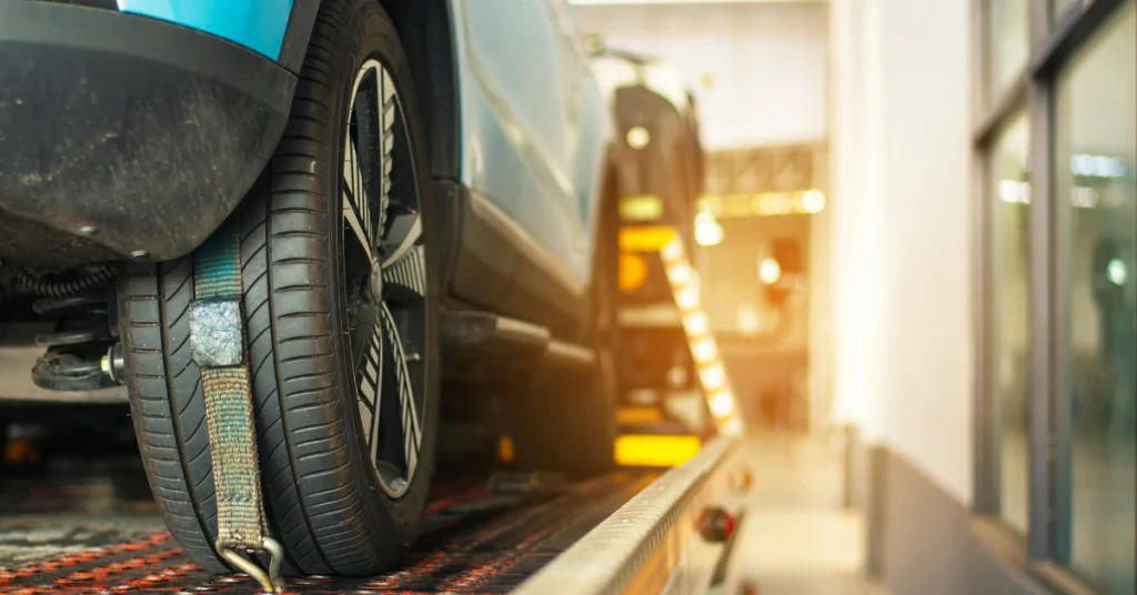 Close-up of a secured car tire on a tow truck