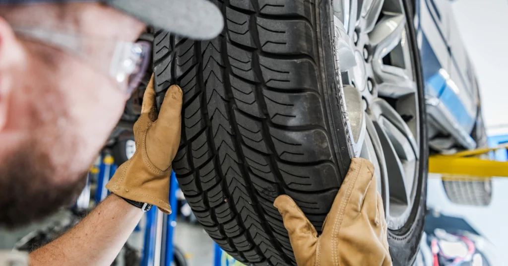 Mechanic inspecting and installing a new tire 