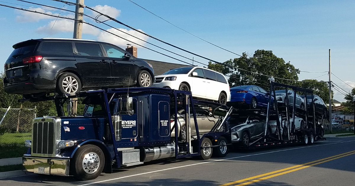 Professional tow truck preparing to transport a car for a 100-mile journey